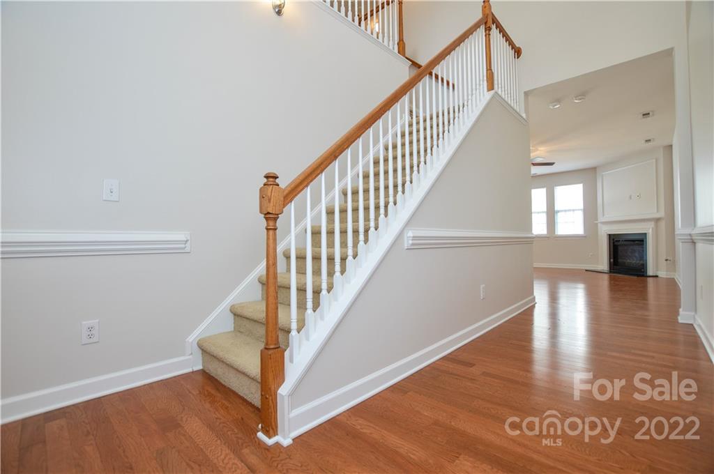 12110 Red Rust Lane Charlotte, NC 28277 - Photo 5 of 36 a view of a hallway with wooden floor and staircase