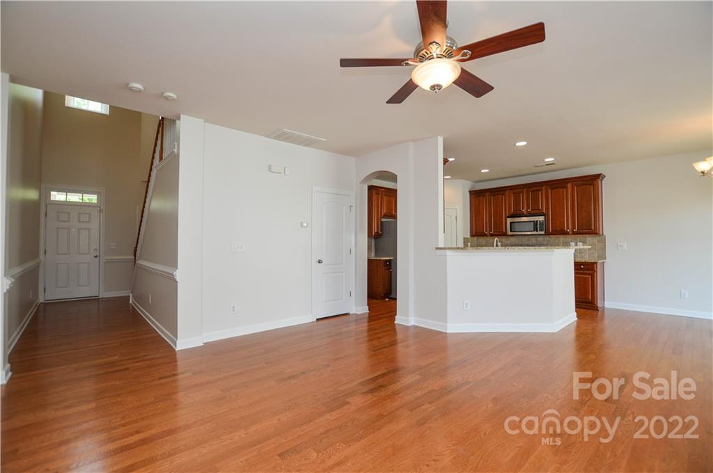 12110 Red Rust Lane Charlotte, NC 28277 - Photo 8 of 36 a view of a kitchen with a microwave and a ceiling fan
