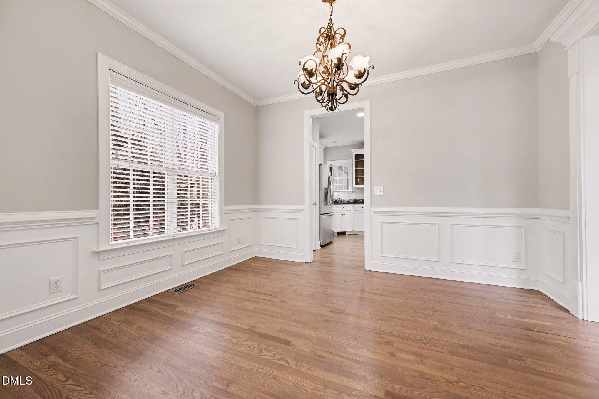 4613 Cherrybark Lane Raleigh, NC 27616 - Photo 9 of 27 a view of an empty room with a window and wooden floor