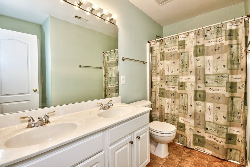 7624 Derek Drive Raleigh, NC 27613 - Photo 22 of 25 Double vanity again located on the second floor with tub/shower combo. One of the bedrooms is directly accessible from the room so super convenient. Bathroom