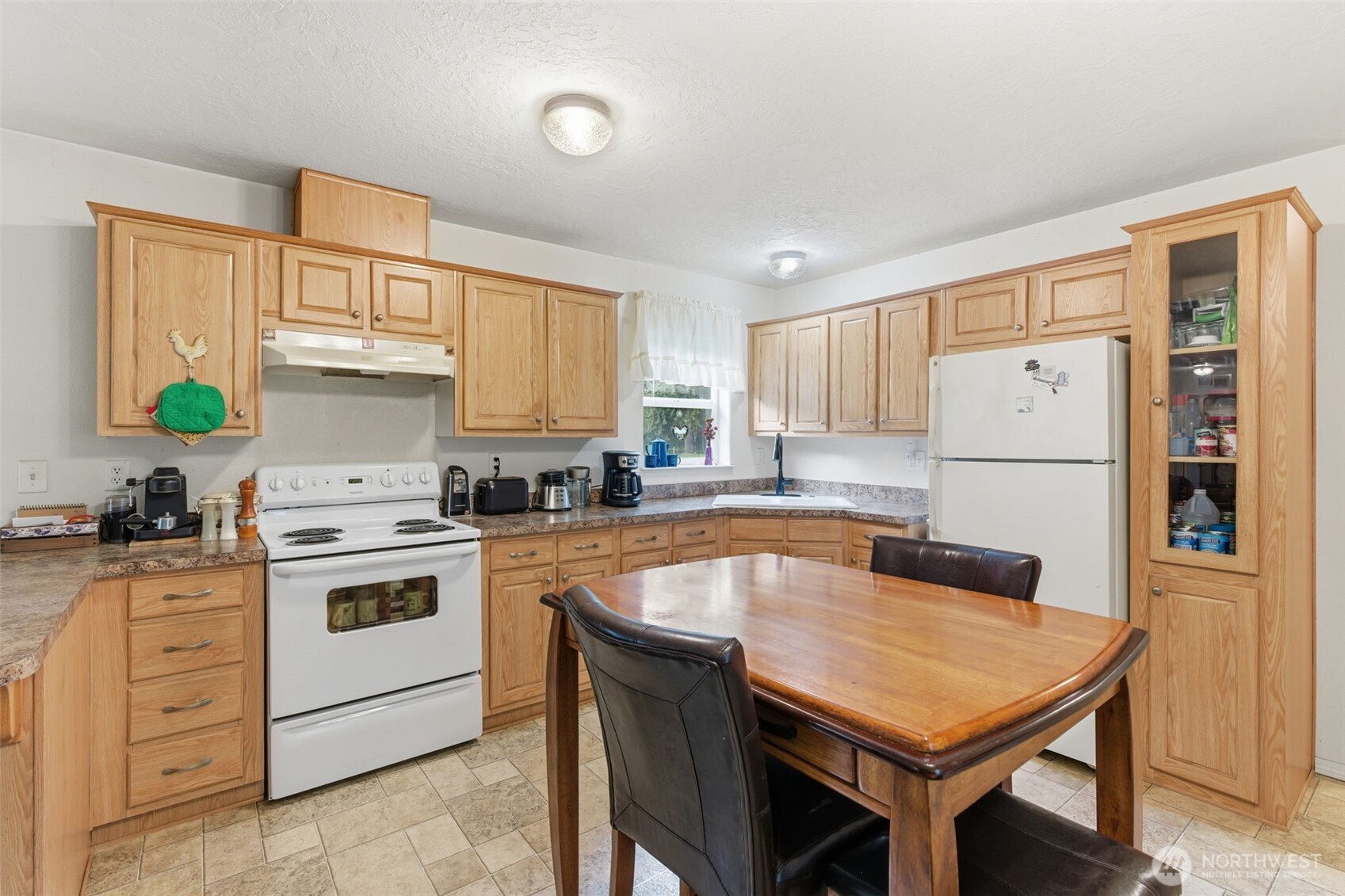 19141 Joselyn Road Southwest Rochester, WA 98579 - Photo 13 of 27 a kitchen with stainless steel appliances granite countertop a stove a refrigerator a sink a stove and white cabinets