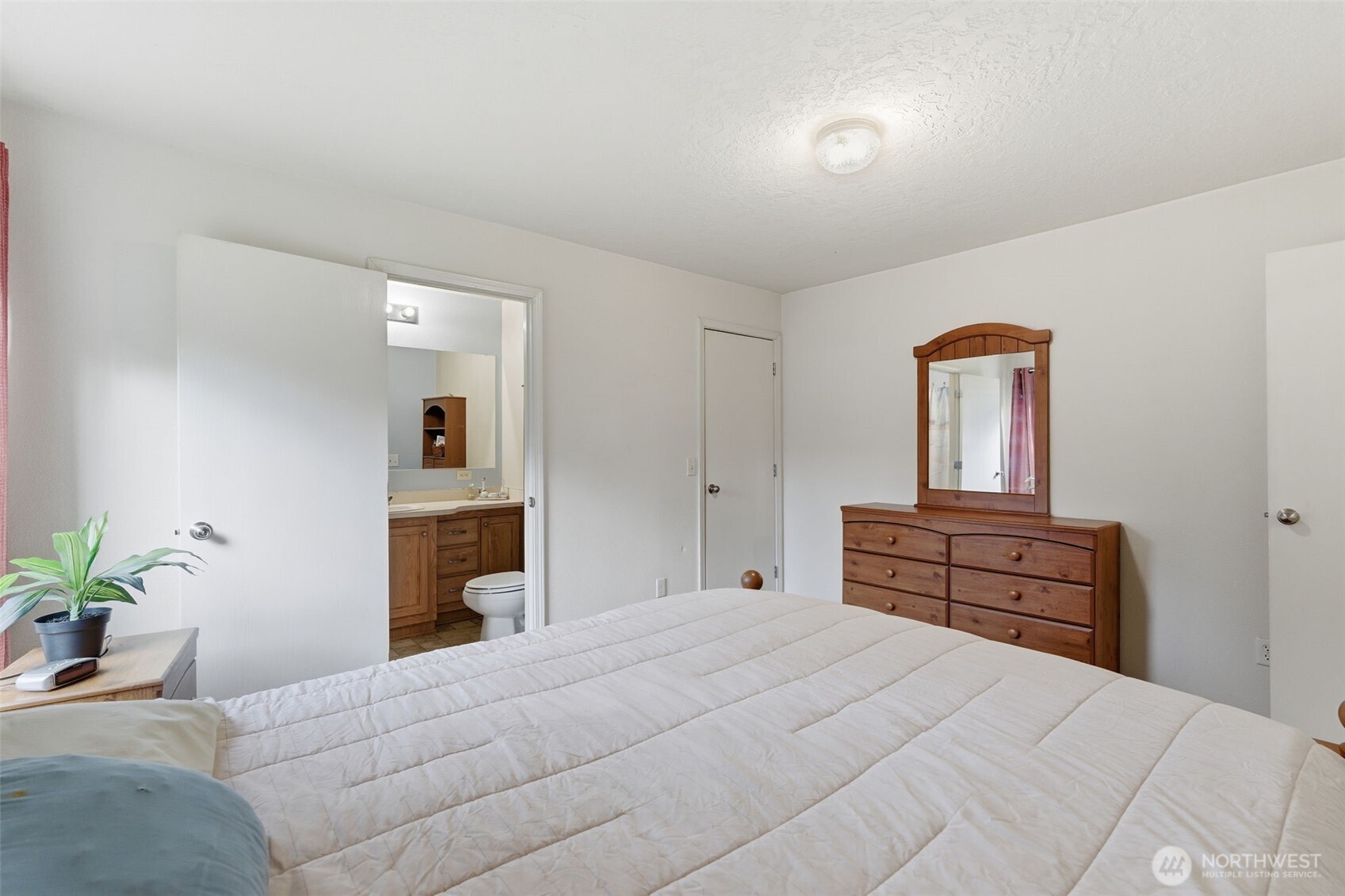 19141 Joselyn Road Southwest Rochester, WA 98579 - Photo 14 of 27 a bedroom with a bed and a dresser
