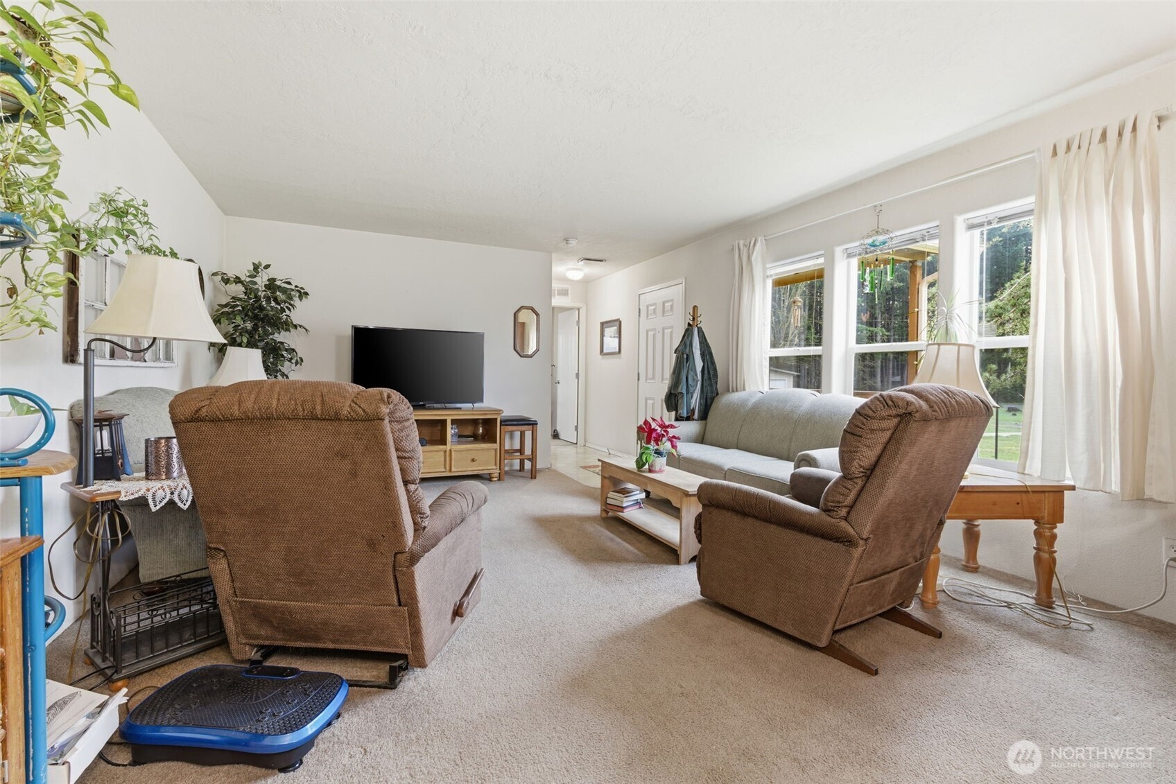 19141 Joselyn Road Southwest Rochester, WA 98579 - Photo 7 of 27 a living room with furniture and a flat screen tv