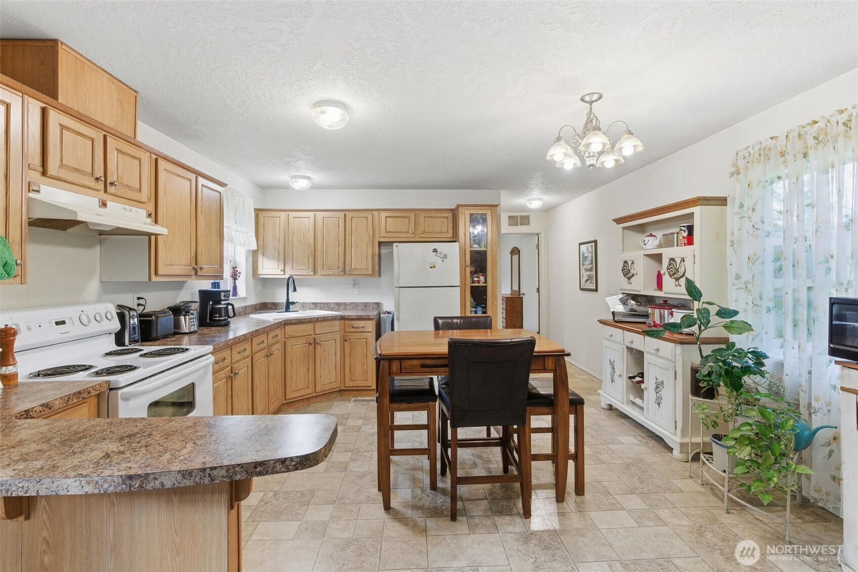 19141 Joselyn Road Southwest Rochester, WA 98579 - Photo 10 of 27 a kitchen with kitchen island granite countertop counter top space a sink stainless steel appliances and cabinets