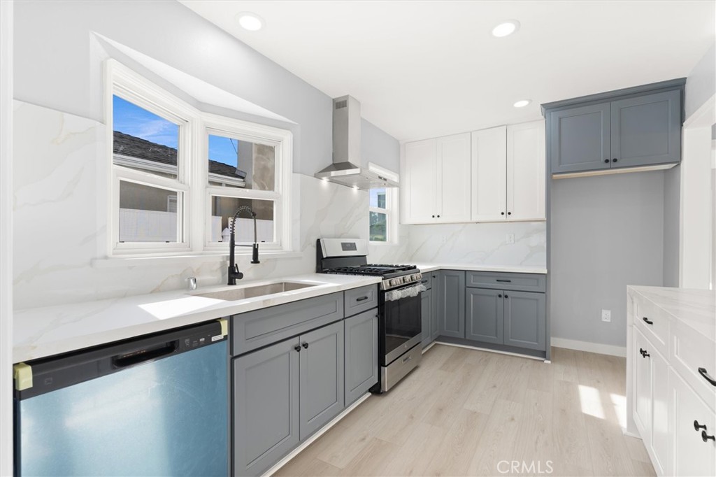 8460 Truxton Avenue Los Angeles, CA 90045 - Photo 13 of 41 a kitchen with a sink stove and cabinets