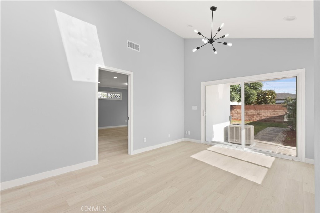 8460 Truxton Avenue Los Angeles, CA 90045 - Photo 17 of 41 an empty room with chandelier fan and windows