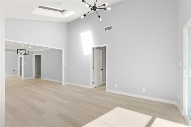 an empty room with fan and entrance