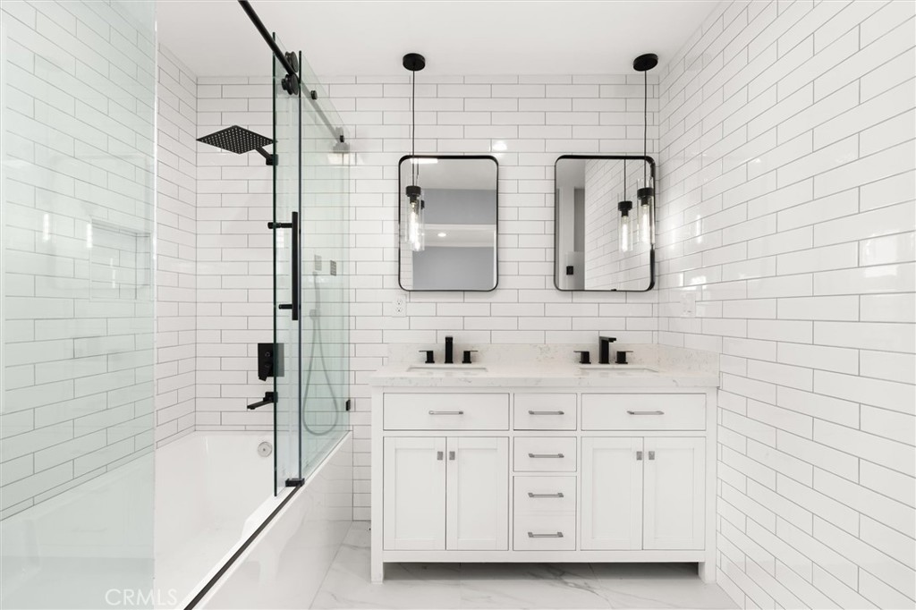 8460 Truxton Avenue Los Angeles, CA 90045 - Photo 24 of 41 a bathroom with a double vanity sink a mirror and bathtub