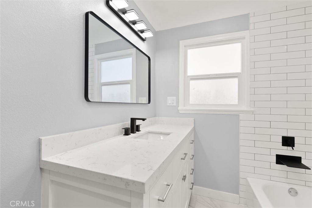 8460 Truxton Avenue Los Angeles, CA 90045 - Photo 28 of 41 a bathroom with a sink a vanity and a bathtub