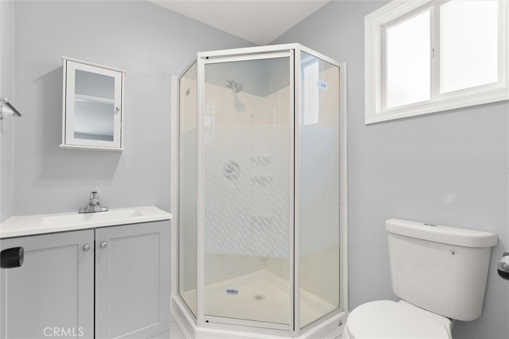 8460 Truxton Avenue Los Angeles, CA 90045 - Photo 38 of 41 a bathroom with a shower sink vanity and toilet