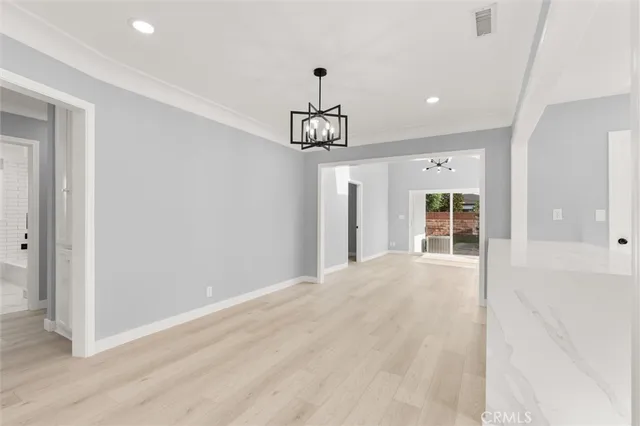a view of a room with wooden floor and windows