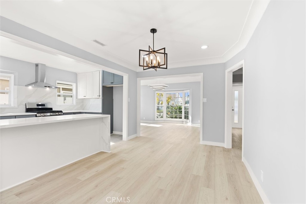 8460 Truxton Avenue Los Angeles, CA 90045 - Photo 9 of 41 a view of a kitchen with a sink dishwasher a refrigerator and wooden floor