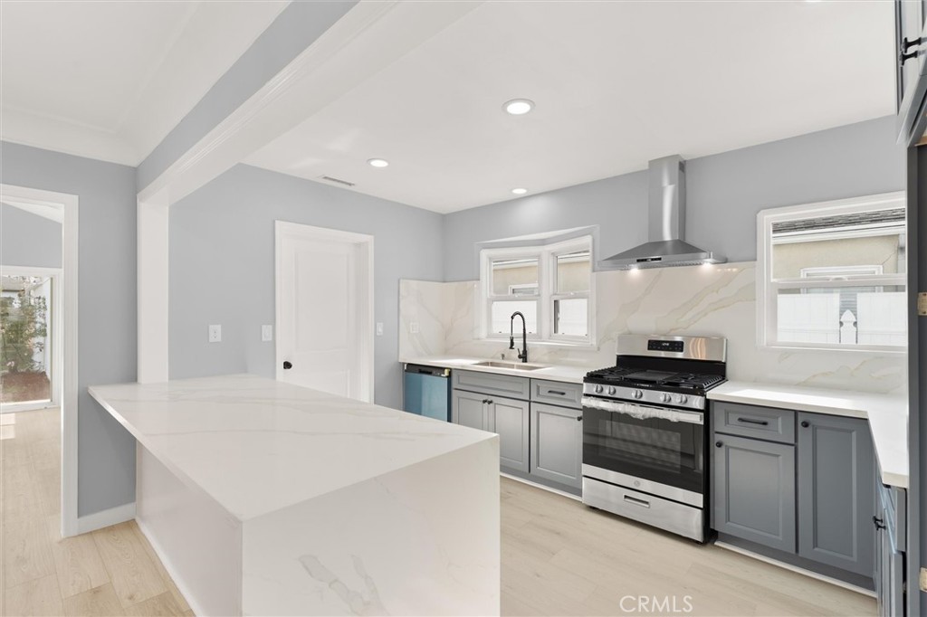 8460 Truxton Avenue Los Angeles, CA 90045 - Photo 10 of 41 a kitchen with stainless steel appliances a stove a sink and a refrigerator