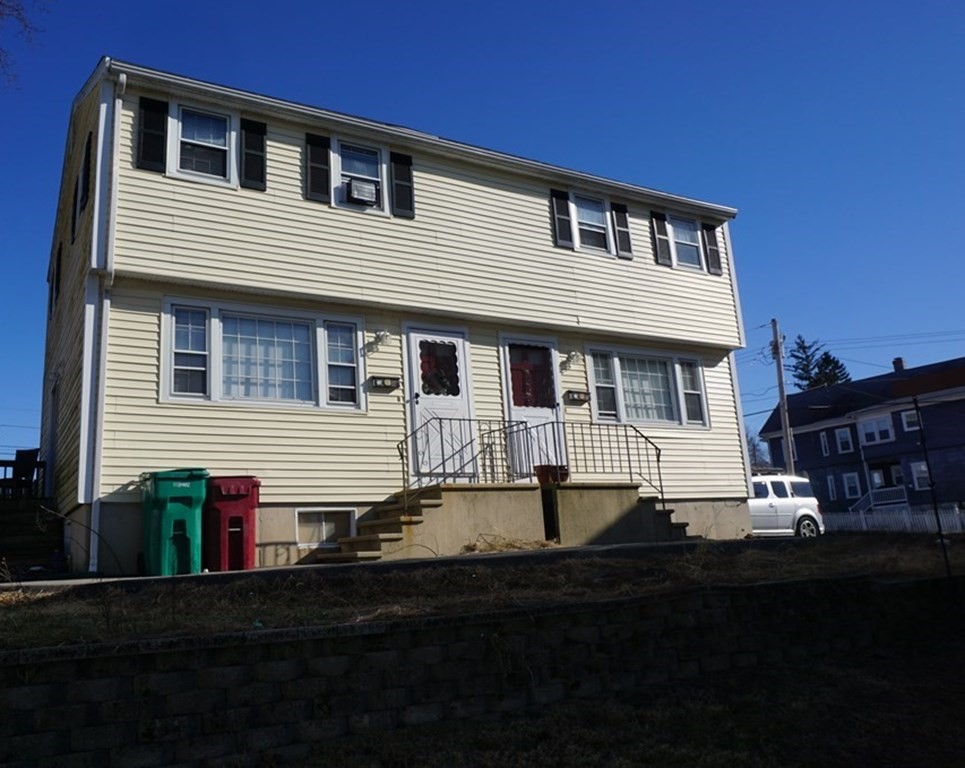 210 3rd Street Lowell, MA 01850 - Photo 1 of 18 a front view of a house with a yard