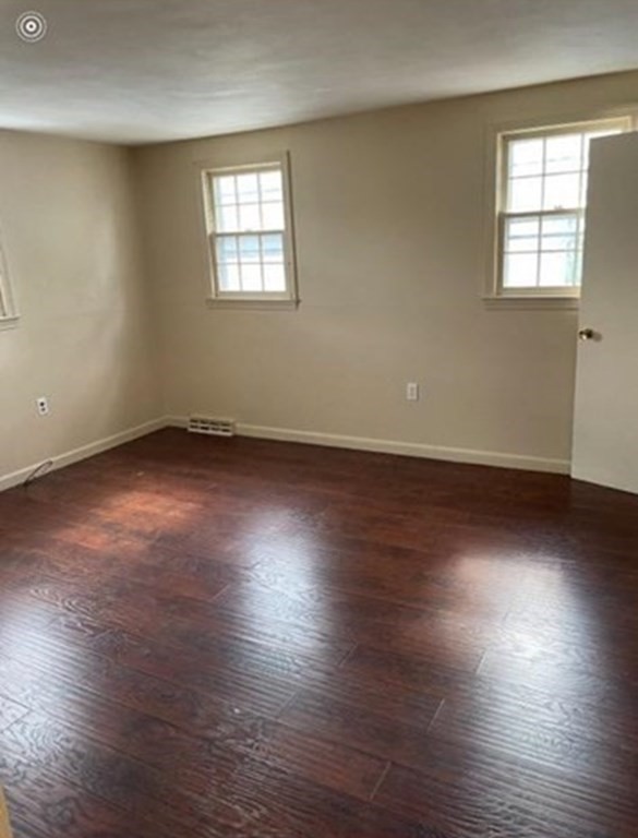 210 3rd Street Lowell, MA 01850 - Photo 12 of 18 an empty room with wooden floor and windows