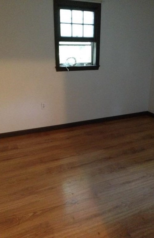 210 3rd Street Lowell, MA 01850 - Photo 14 of 18 a view of a room with wooden floor and fan