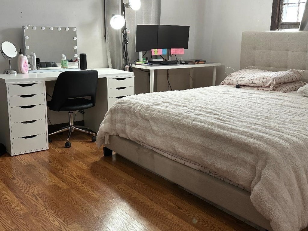 210 3rd Street Lowell, MA 01850 - Photo 17 of 18 a bedroom with a bed and a chair