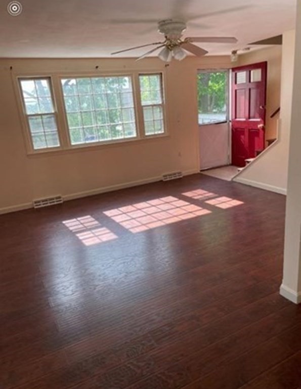 210 3rd Street Lowell, MA 01850 - Photo 6 of 18 a view of empty room with wooden floor and fan