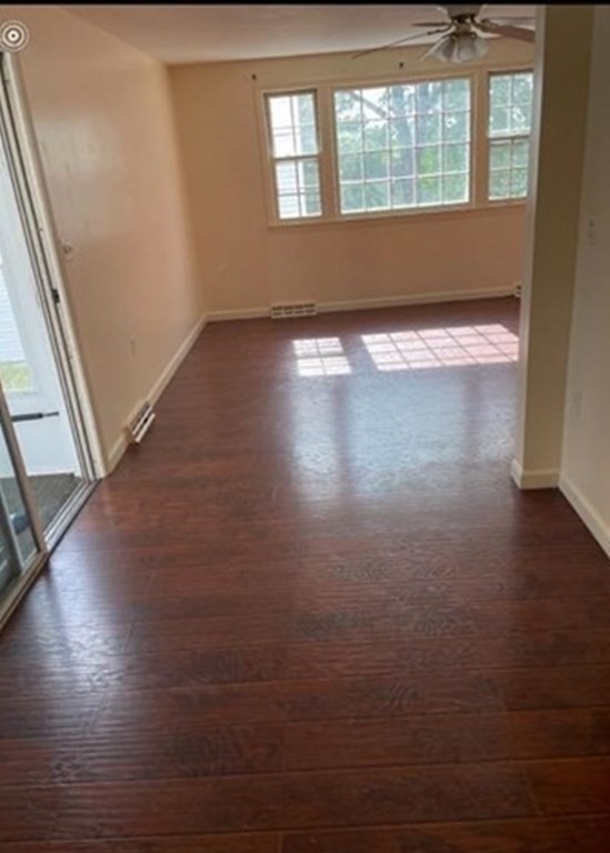 210 3rd Street Lowell, MA 01850 - Photo 7 of 18 an empty room with wooden floor and windows