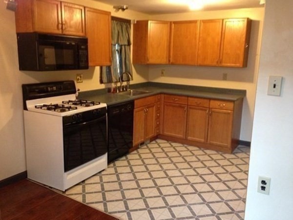 210 3rd Street Lowell, MA 01850 - Photo 8 of 18 a kitchen with a stove and a microwave