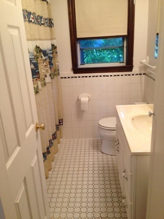 210 3rd Street Lowell, MA 01850 - Photo 9 of 18 a bathroom with a toilet and a tub