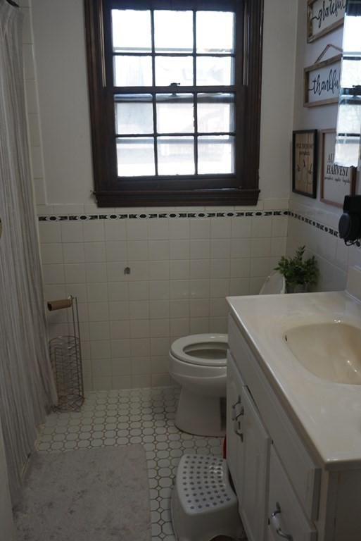 210 3rd Street Lowell, MA 01850 - Photo 10 of 18 a bathroom with a sink and a toilet