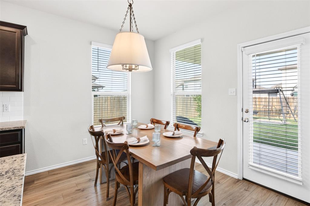 3105 Marston Road Lorena, TX 76655 - Photo 8 of 40 Integrated dining area featuring wood-finish flooring, a contemporary pendant light fixture, and white walls