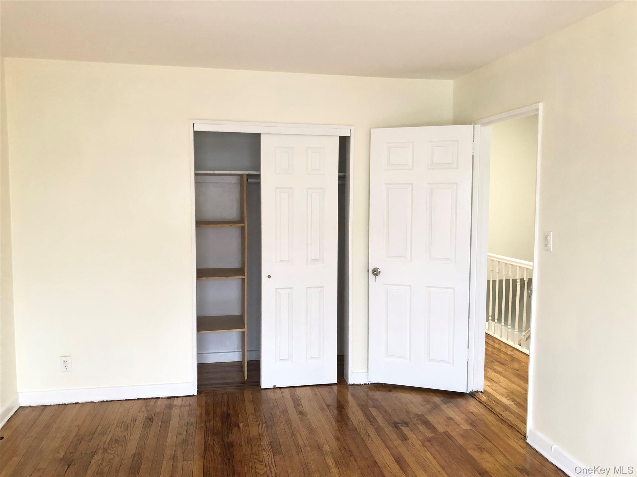148-03 Horace Harding Expressway Queens, NY 11367 - Photo 12 of 18 a view of an empty room with wooden floor