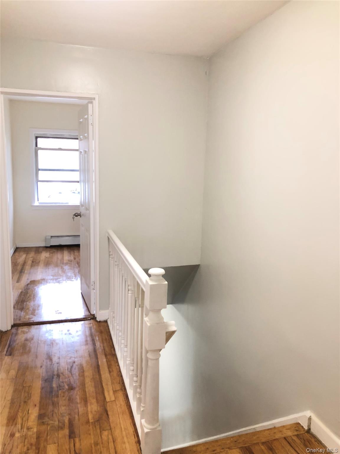 148-03 Horace Harding Expressway Queens, NY 11367 - Photo 8 of 18 a view of a hallway with wooden floor and staircase