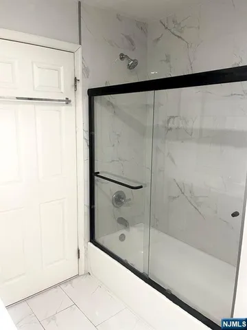 a bathroom with a glass shower door