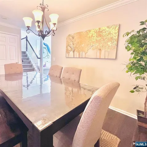 a view of a dining room with furniture and a chandelier
