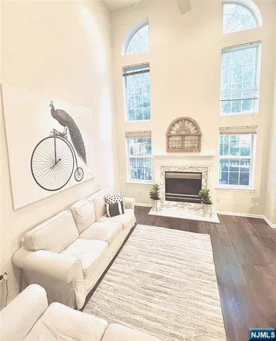 a living room with furniture a fireplace and a large window
