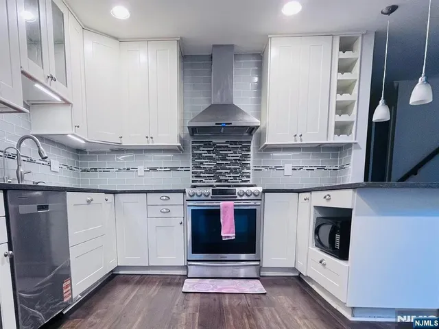 a kitchen with stainless steel appliances granite countertop a stove and a sink