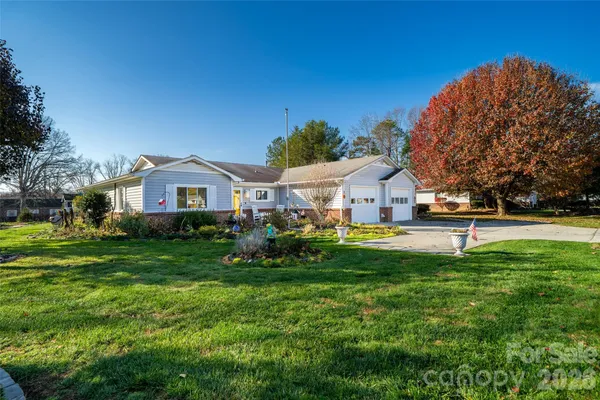 a front view of a house with a garden
