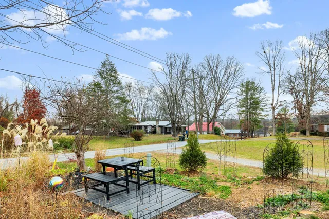 a view of a swimming pool with a patio and garden