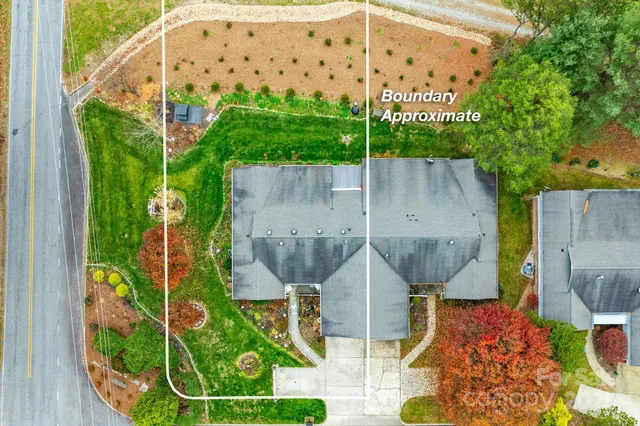 an aerial view of a house with garden space and street view