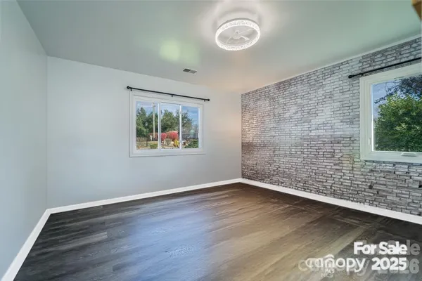 a view of a room with wooden floor and window