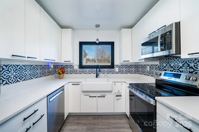 a kitchen with a sink stove and cabinets