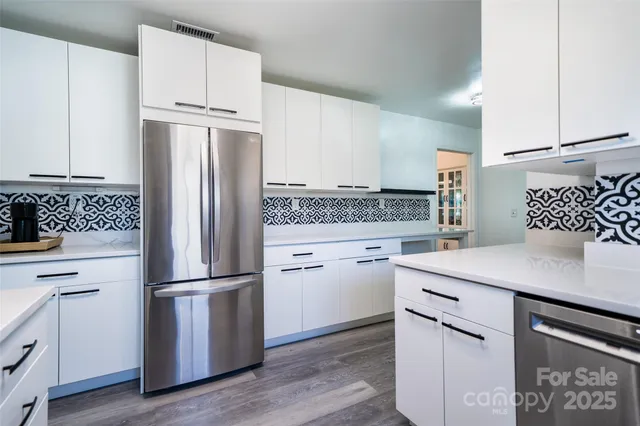 a kitchen with appliances cabinets and a sink