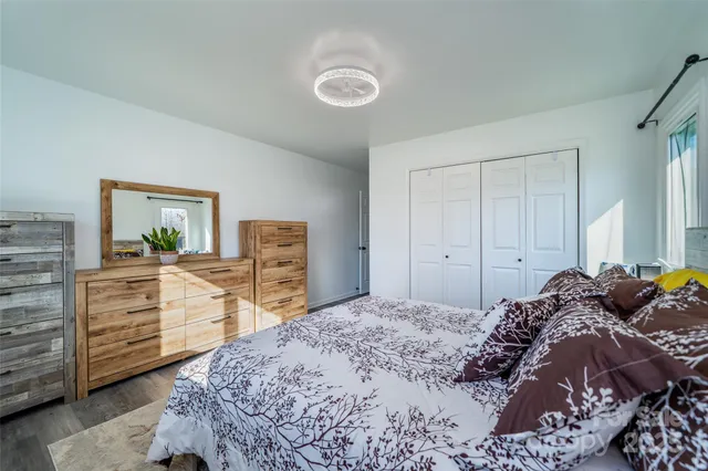 a bedroom with a bed and a dresser