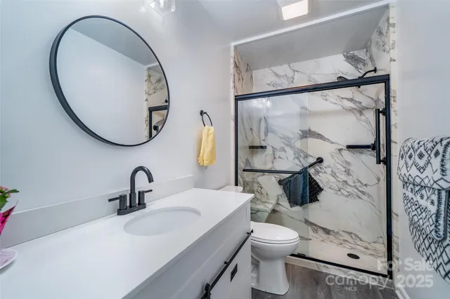 a bathroom with a toilet sink and a mirror