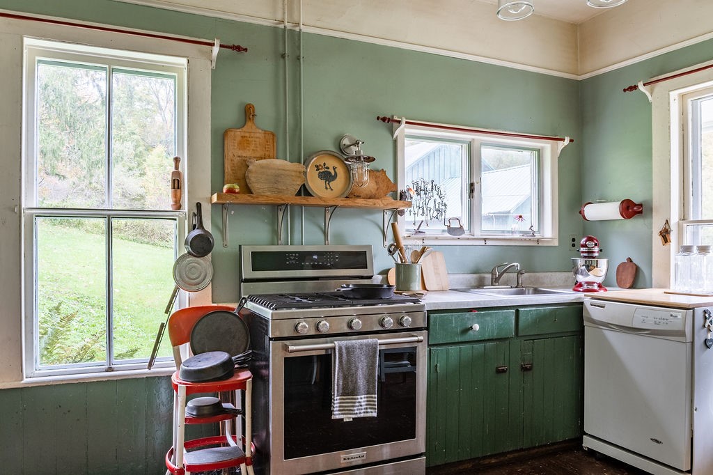 67 Fisk Road Bovina, NY 13753 - Photo 9 of 48 Vintage charm defines this kitchen featuring classic wood cabinetry and abundant natural light.