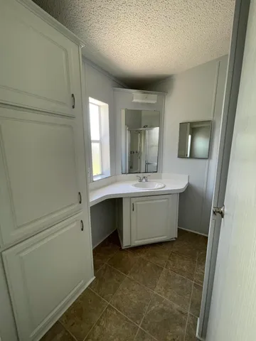 a bathroom with a double vanity sink a mirror and a bathtub