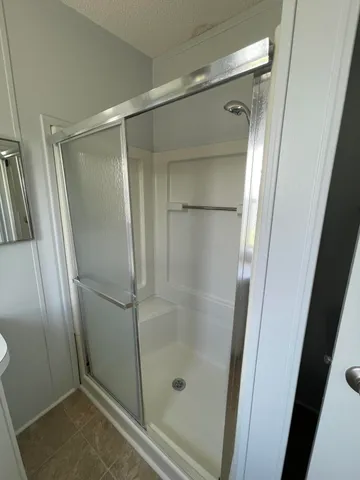 a bathroom with a glass door shower