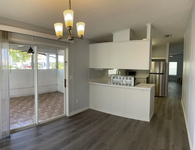 a room with wooden floor and white walls