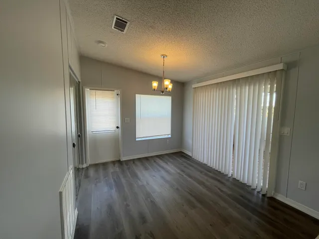 a view of a room with wooden floor and window