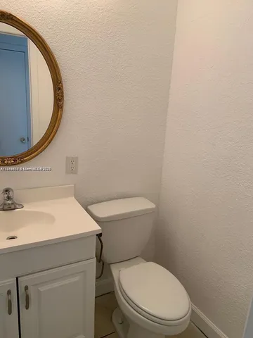 a white toilet sitting next to a bathroom sink