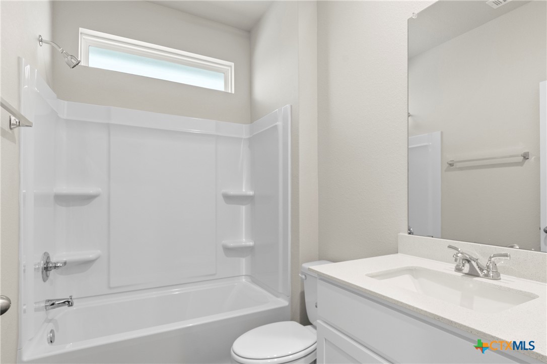 3035 Winding Creek Road Kyle, TX 78640 - Photo 17 of 38 a bathroom with a sink toilet and bathtub