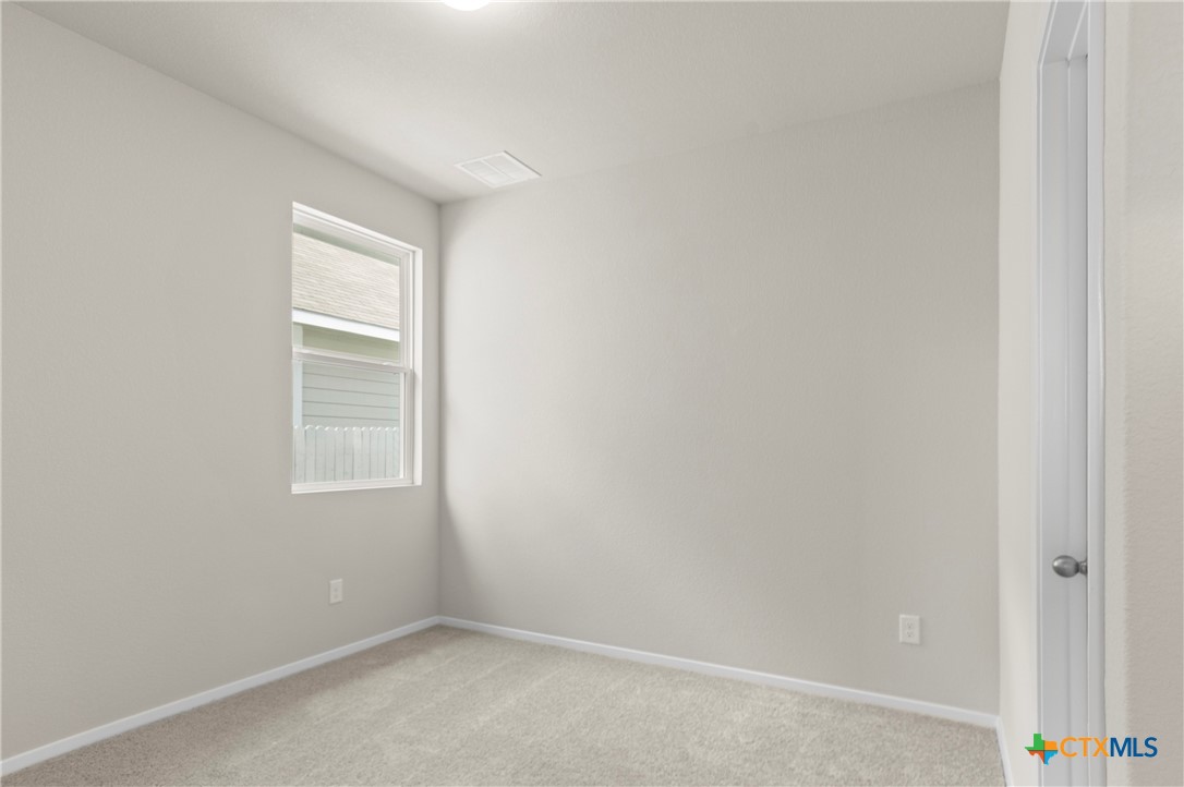3035 Winding Creek Road Kyle, TX 78640 - Photo 18 of 38 a view of an empty room with a window