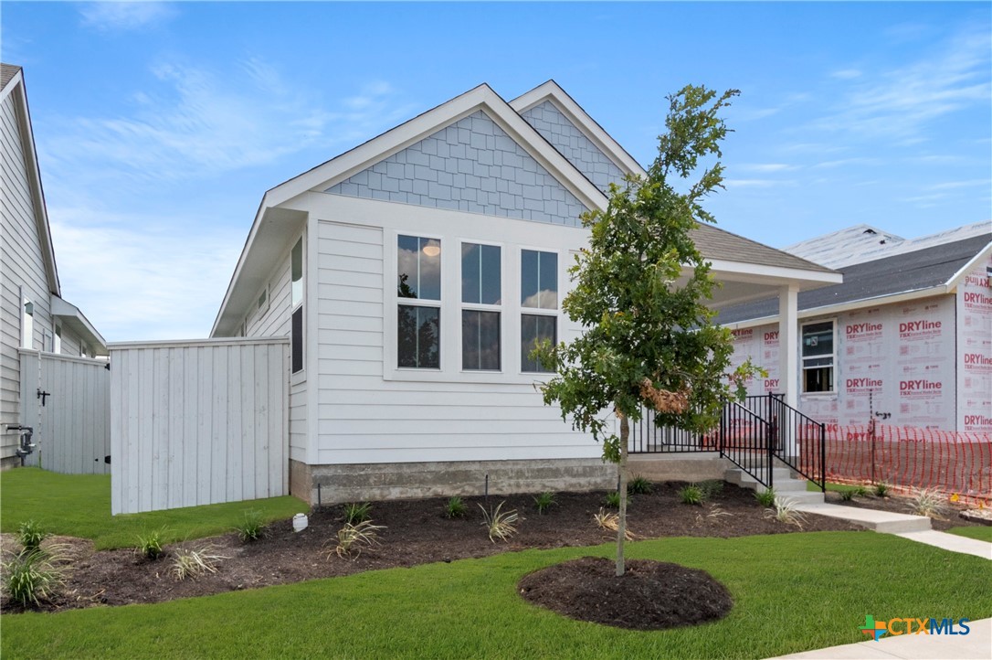 3035 Winding Creek Road Kyle, TX 78640 - Photo 24 of 38 a front view of a house with a garden and plants